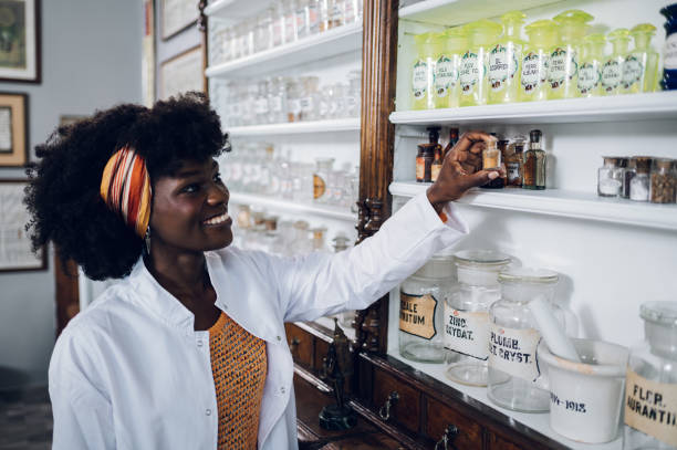 istock African american pharmacist is taking a medicament ingredient. 1694103193