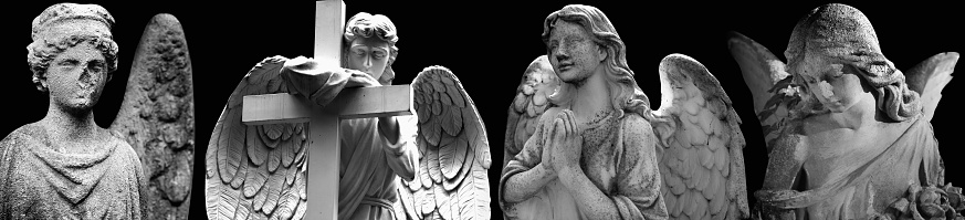 Angels against black backgrouund. Ancient statues. Black and white horizontal image.