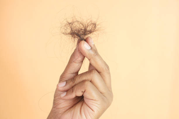 istock man hold his list hair close up 1694117314