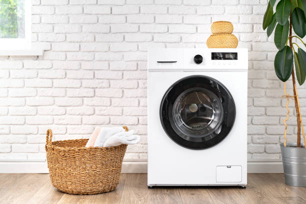 istock Washing machine and basket in a laundry room 1694117883