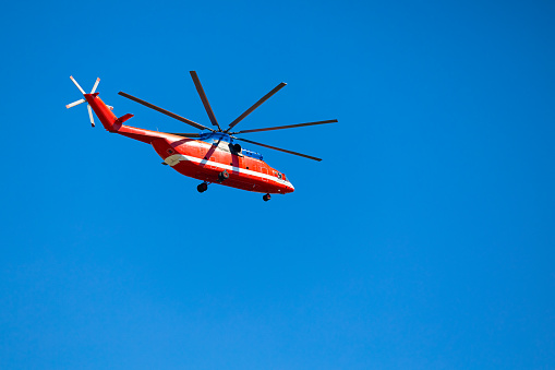 Moscow, Russia - August 04, 2023: big red helicopter against the blue sky . helicopter mi 26