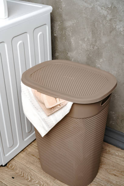 istock Laundry basket with dirty towels in a bathroom 1694137541