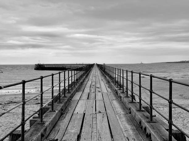 istock Diminishing perspective on a wooden pier at Blyth 1694141055