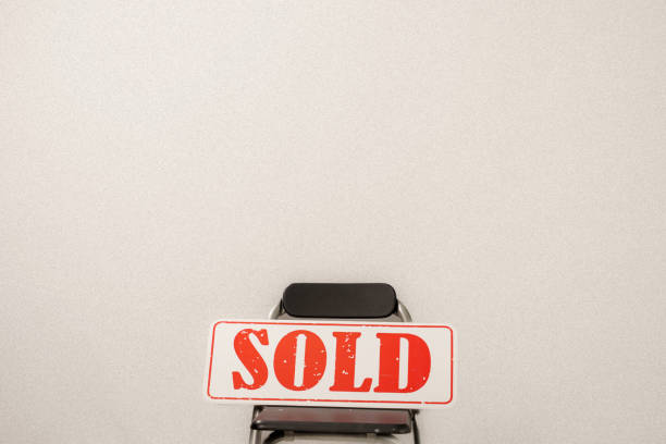 A sold sign outside a house on a residential street that has just been sold.