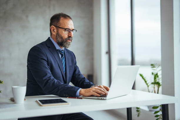 istock Cheerful adult man with glasses, taking notes on the conference call. 1694148302