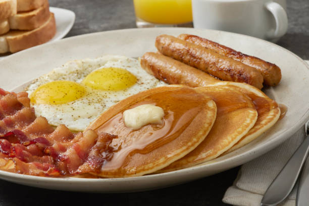 istock Grand Slam Breakfast with Pancakes, Bacon, Sasuage, Eggs, and Toast 1694152796