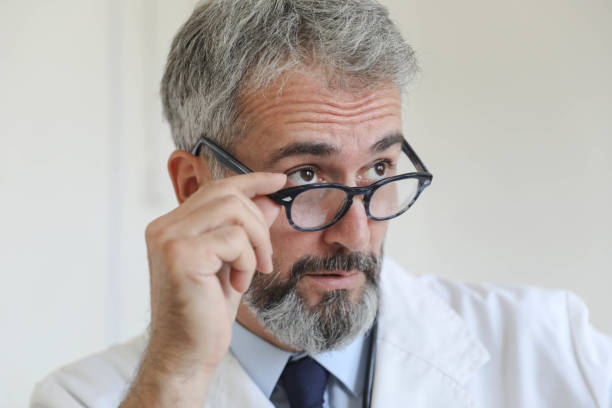 istock Serious doctor with glasses in hand 1694157843