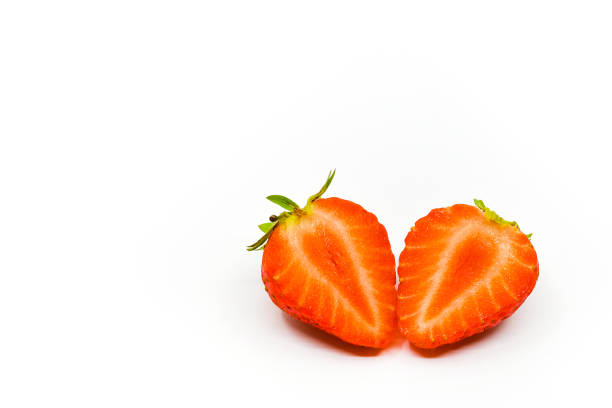 istock Fresh ripe strawberry cut in half on a white background 1694158084