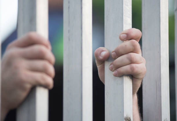 istock prisoner at the window of a prison cell 1694158242