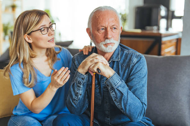 istock Geriatrician helping lonely elderly crying man. 1694166411
