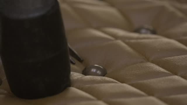 hammer tufting leather furniture close up