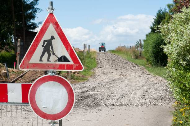 istock Vibrant red road sign in front of a building site 1694192940