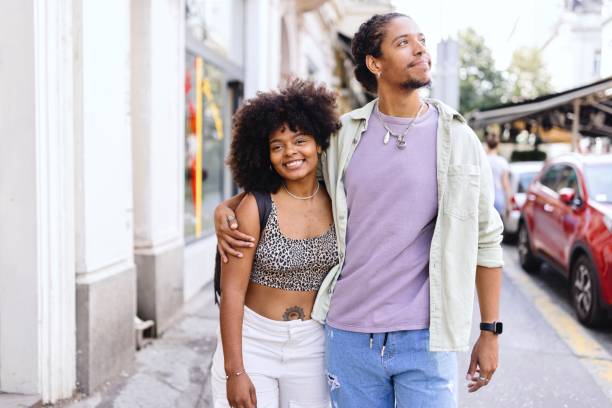 istock Smiling couple walking around the city 1694195322