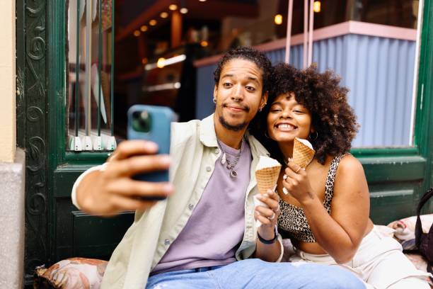 istock Happy couple taking a selfie while eating ice cream 1694198190