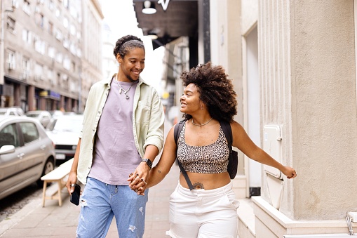 Carefree multiracial couple walking down the street