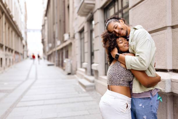 istock Couple hugging on the street 1694211812