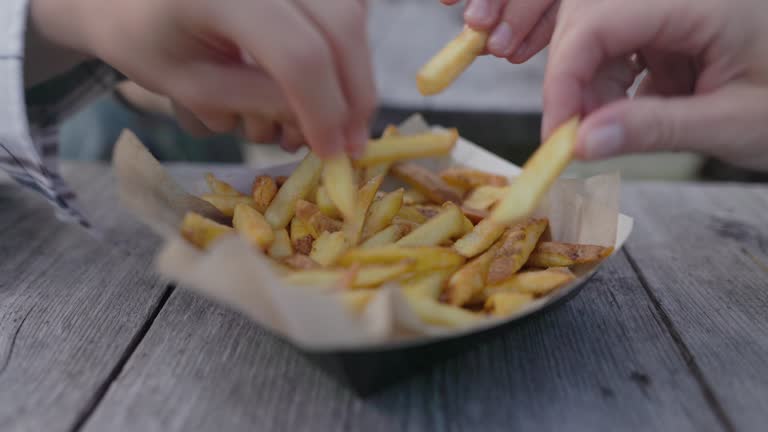 Family enjoying fresh French Fries with the skin for lunch