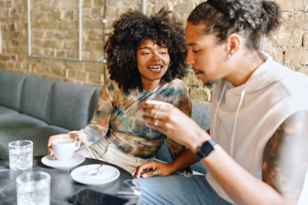 istock Couple drinking coffee and talking at the cafe 1694215391