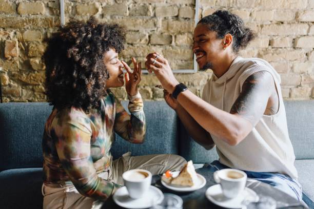 istock Boyfriend and girlfriend sharing a dessert at the cafe 1694215518
