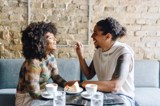 istock Carefree couple sharing a dessert in the cafe 1694215519