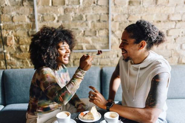 istock Couple sharing a cake at the cafe 1694216041