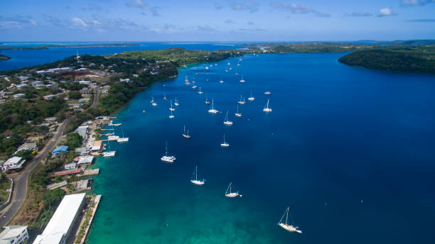 istock Aerial view of pristine blue boat harbor with multiple yachts moored in Tonga 1694217135