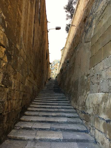 istock Walled sidestreet with steps in Valeta, Malta with no people 1694234073