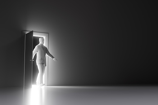 Conceptual 3D illustration of male business man walking through door with glowing light into room.