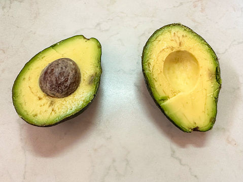 Fresh opened avocado on white background stock photo - vegan healthy food