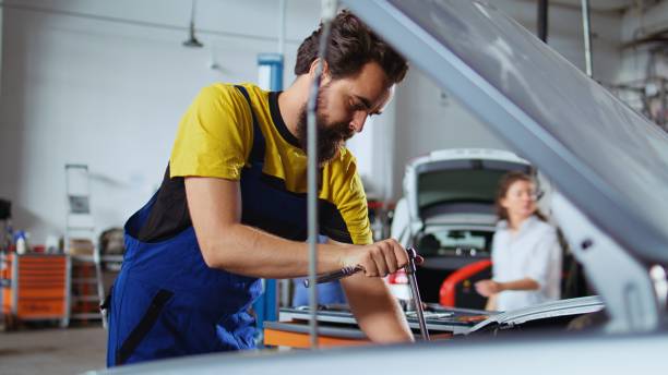istock Worker replaces car engine in garage 1694258252