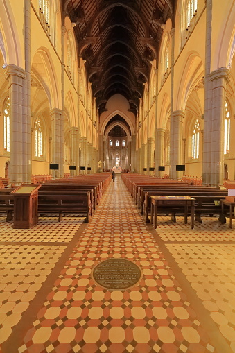 Melbourne, Australia-October 22, 2018: The Geometric Decorated Gothic revival style St.Patrick's Cathedral interior displays a central nave, a lateral aisle on each side, a point-arched wood ceiling.