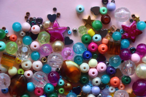 istock Colorful Beads on Pink Background 1694324040