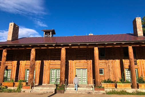 Los Alamos, NM: A man at the historic Fuller Lodge designed by architect John Gaw Meem; the school bell on top dates from the origins of the Lodge—when it served as a schoolhouse.