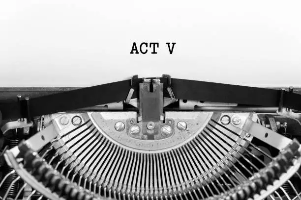 Photo of Act Five word closeup being typing and centered on a sheet of paper on old vintage typewriter mechanical