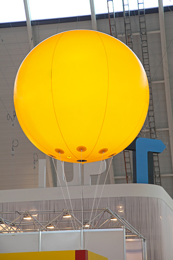 Big Yellow Advertisement Balloon in Exhibition Hall Copy Space