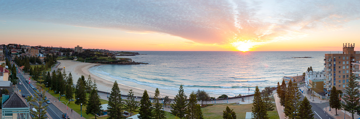 Wide angle panoramic view of Coogee Beach on sunrise looking over the whole beach on Sydney's Eastern Beaches.