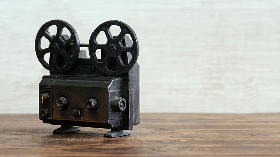 Film reel video tape with golden statue and movie clapper board.