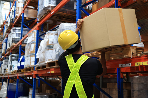 Warehouse staff move and arrange cartons of goods in the warehouse, logistics and warehouse concept