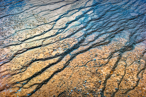 Colorful mineral deposits in the Fountain Paint Pot area in Yellowstone National Park, close-up, natural background.