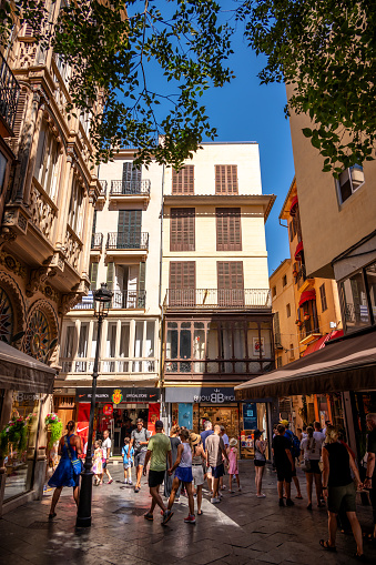 Palma de Mallorca, Spain - July 28, 2023: tourists exploring beautiful narrow, medieval street scenes in Palma's old city.