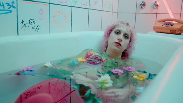 Portrait of Fashion Model in Bathwater with Flowers
