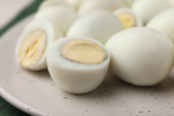 istock Many peeled hard boiled quail eggs on plate, closeup 1694455812