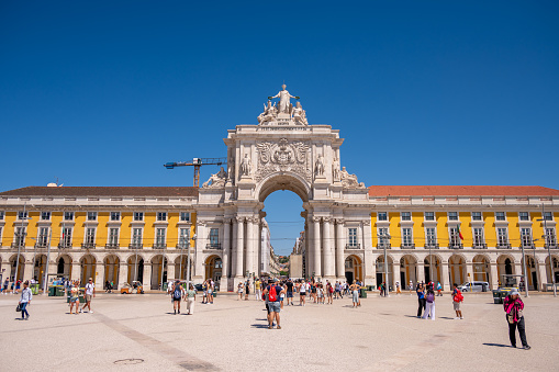 Lisbon, Portugal - July 30, 2023: Tourists visiting the beautiful Rua Augusta Arch in Lisbon's old city.