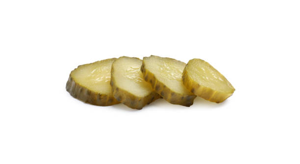 istock Slices of pickled cucumbers on white background 1694458537