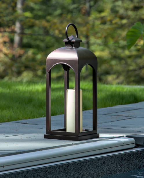 istock large light fixture shaped like a candle holder poolside (side of a pool with green grass) lantern outdoor 1694478184