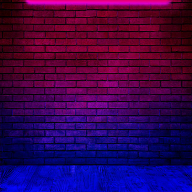 istock Glowing neon lamp on brick wall in room 1694504622
