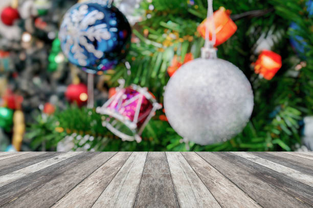 istock Empty wood table top with blur Christmas tree with bokeh light background 1694504900