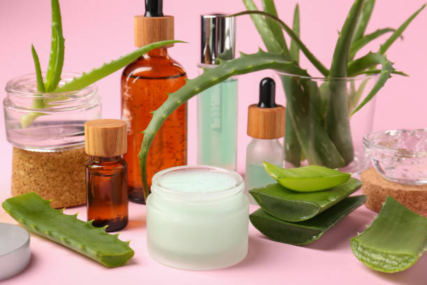 istock Cosmetic products and cut aloe on pink background 1694505033