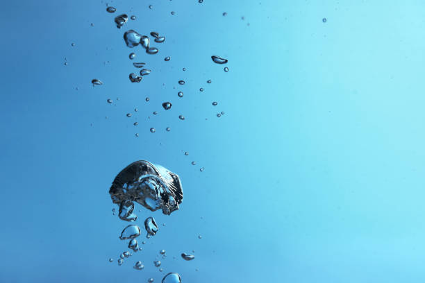 istock Air bubbles in water on light blue background. Space for text 1694507200