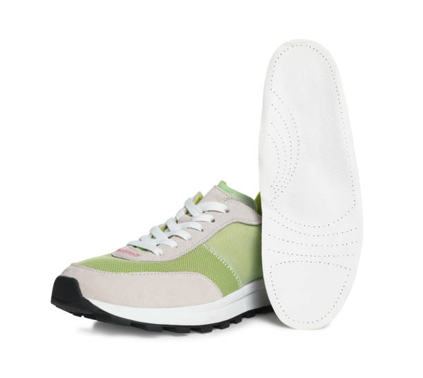 istock Orthopedic insole near shoe on white background 1694507219